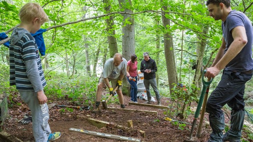Volunteers helping to create steps in the woodland at Chedworth Roman Villa, Gloucestershire